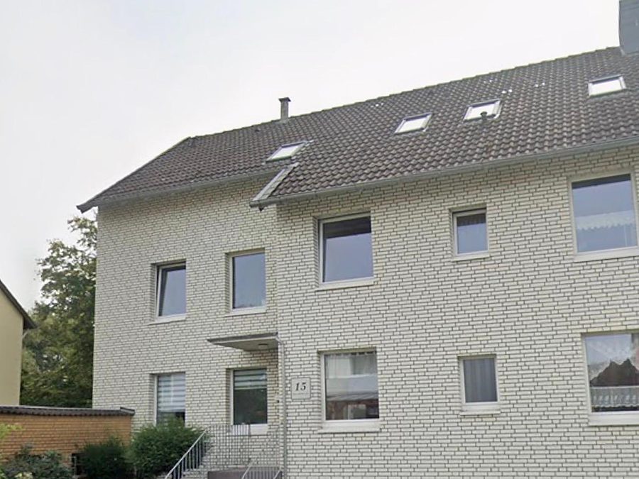 Mehrfamilienhaus aus den 1960er-Jahren mit hellem Klinkermauerwerk und Satteldach